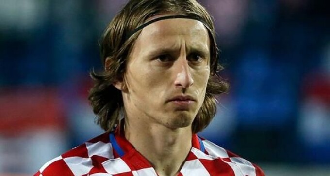 футболист с капитанской повязкой с решительным лицом